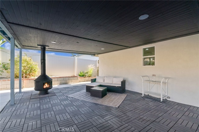 view of patio with an outdoor living space with a fire pit