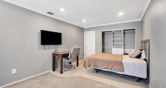 bedroom featuring ornamental molding and a closet