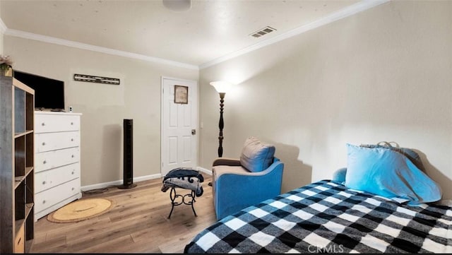 bedroom featuring crown molding and hardwood / wood-style flooring