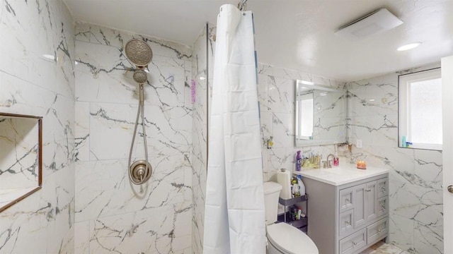 full bath with toilet, a healthy amount of sunlight, a marble finish shower, and vanity