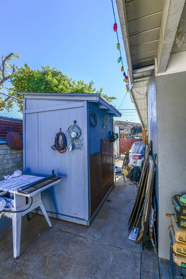 view of outbuilding featuring fence