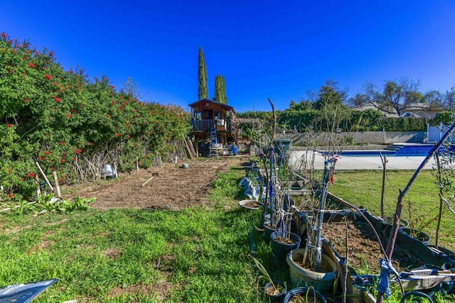 exterior space featuring a fenced in pool and a yard