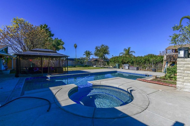 view of swimming pool featuring a fenced in pool, a patio area, a gazebo, and an in ground hot tub