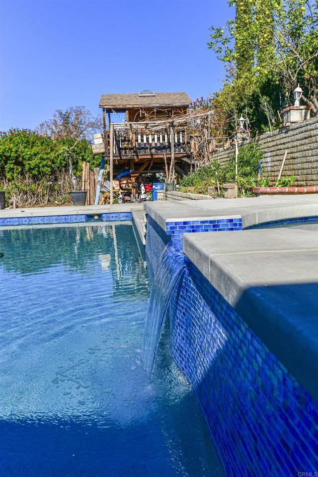 view of pool with a fenced in pool and fence