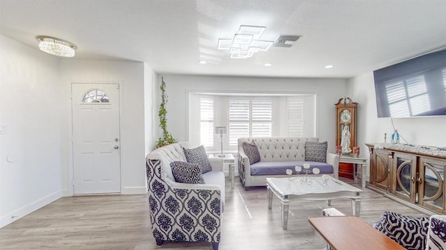 living area featuring recessed lighting, wood finished floors, visible vents, and baseboards