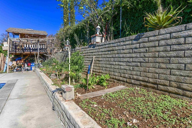 exterior space featuring a garden and fence