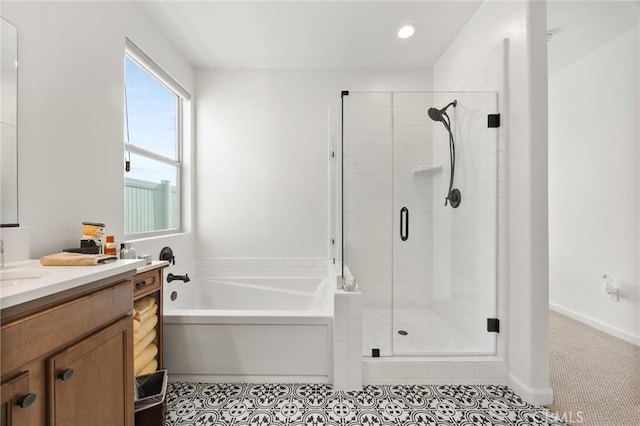 bathroom with tile patterned flooring, vanity, and plus walk in shower