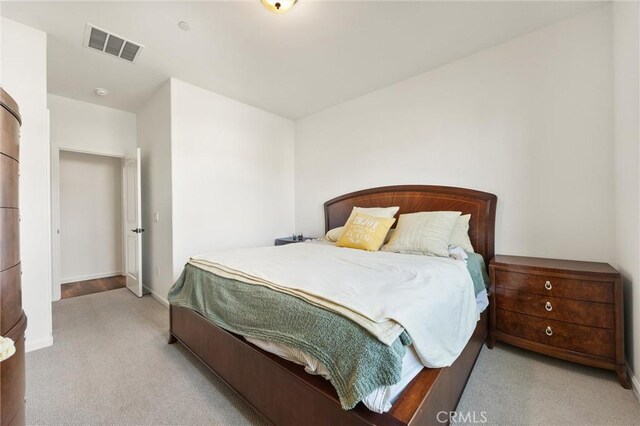 bedroom featuring light colored carpet