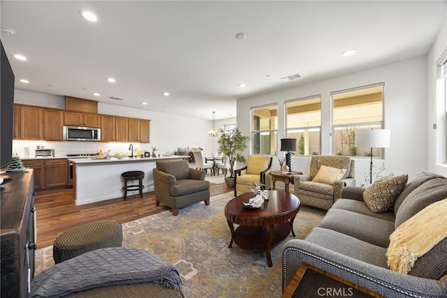 living room featuring dark hardwood / wood-style flooring and sink