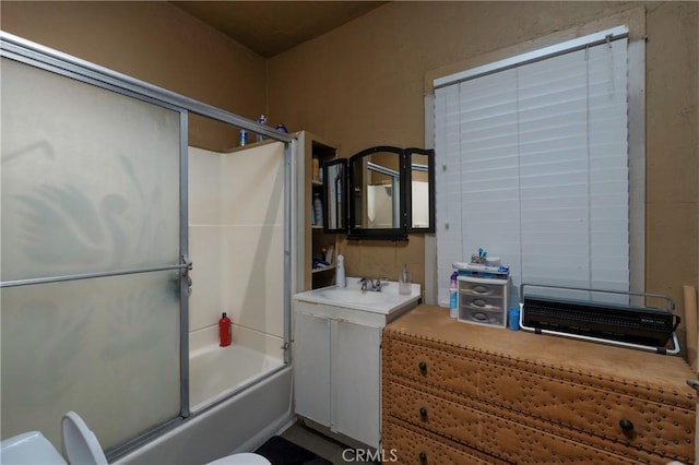 bathroom with vanity and bath / shower combo with glass door