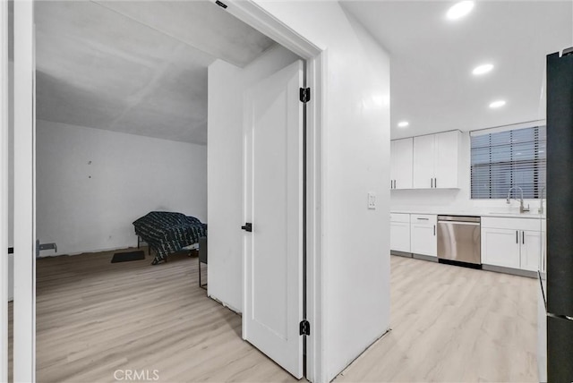 hall featuring sink and light hardwood / wood-style floors