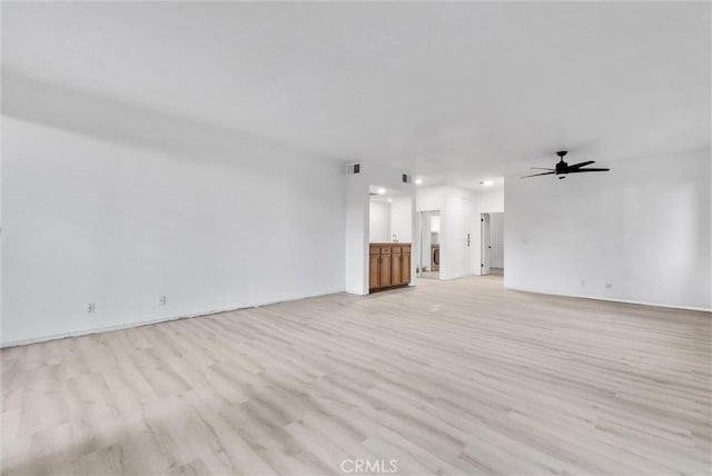 unfurnished living room with light wood-type flooring and ceiling fan