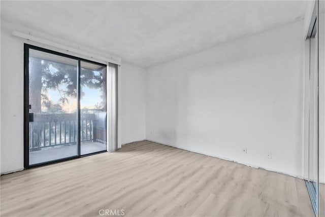 unfurnished room with light hardwood / wood-style flooring