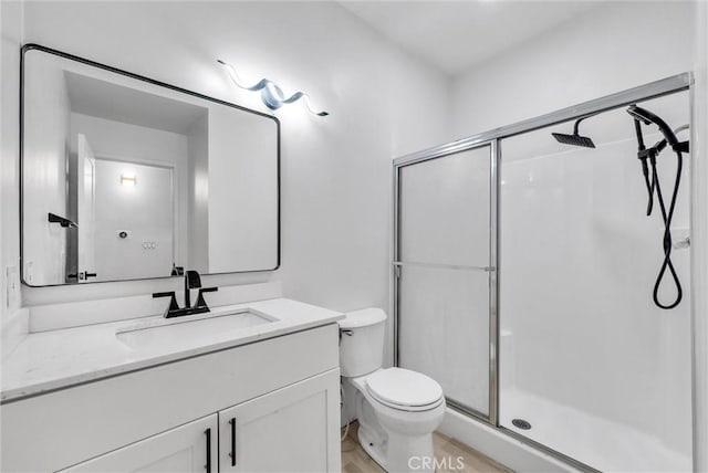 bathroom with toilet, walk in shower, and vanity