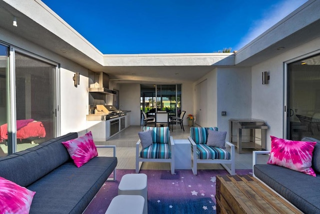 view of patio / terrace featuring exterior kitchen, an outdoor hangout area, and area for grilling