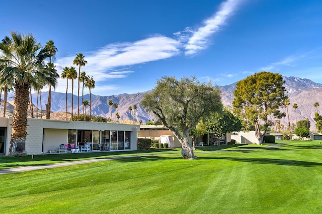 view of community featuring a lawn and a mountain view