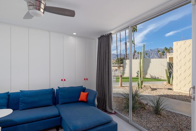 carpeted living room featuring ceiling fan