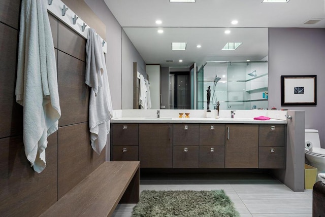 bathroom featuring toilet, an enclosed shower, tile patterned floors, and vanity