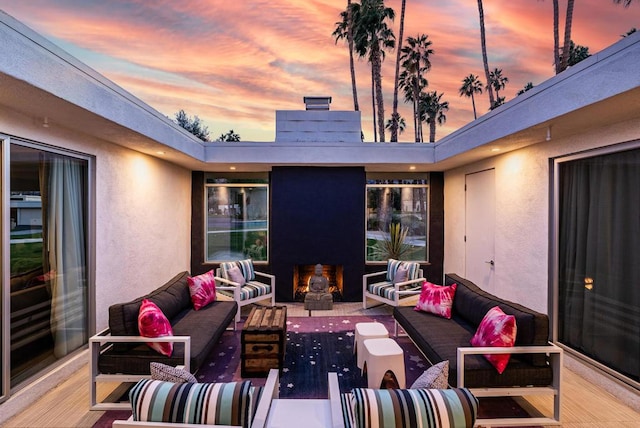 patio terrace at dusk featuring an outdoor hangout area