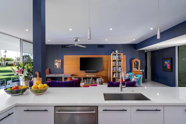 kitchen with dishwasher, pendant lighting, white cabinetry, ceiling fan, and sink