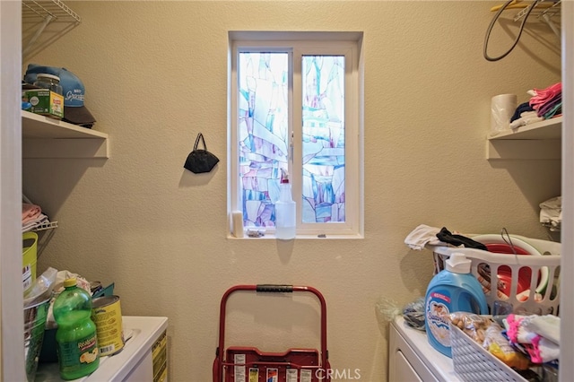 clothes washing area featuring washer and clothes dryer