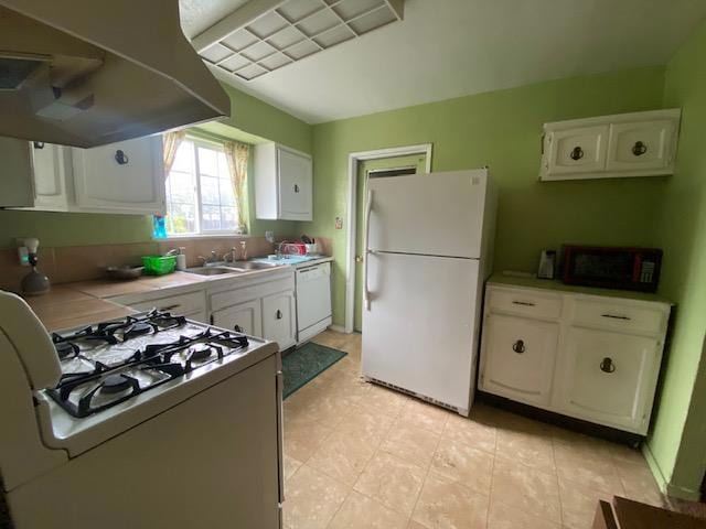 kitchen featuring white appliances, white cabinets, island range hood, and sink