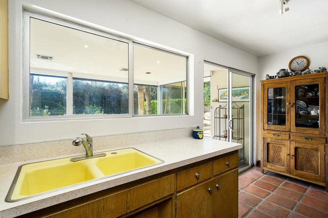 kitchen with sink and dark tile patterned floors