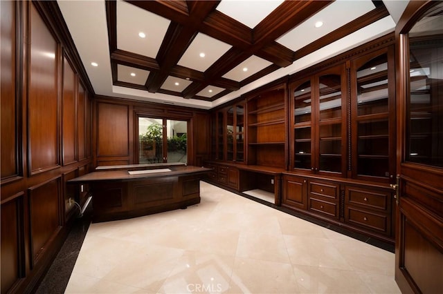 wine room featuring coffered ceiling, crown molding, beamed ceiling, and built in desk