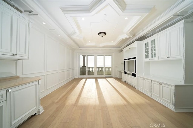 unfurnished living room featuring french doors, crown molding, and light hardwood / wood-style flooring