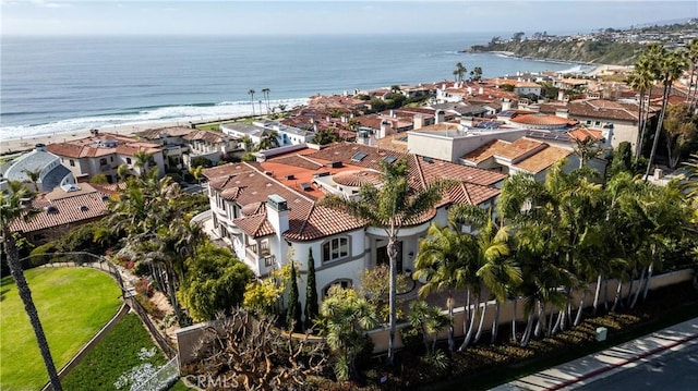 birds eye view of property featuring a beach view and a water view