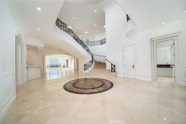 foyer entrance featuring ornamental molding and a high ceiling