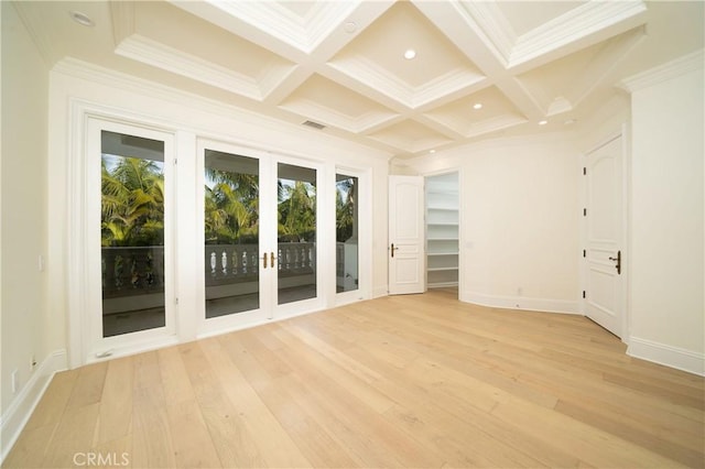 spare room with light hardwood / wood-style floors, crown molding, and coffered ceiling