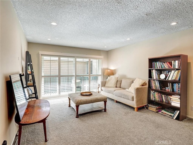 living area with recessed lighting, carpet flooring, and a textured ceiling