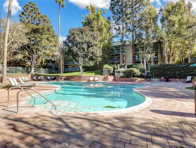 view of swimming pool with a patio area