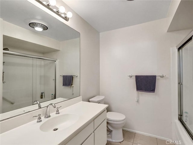 full bath with baseboards, toilet, shower / bath combination with glass door, tile patterned flooring, and vanity