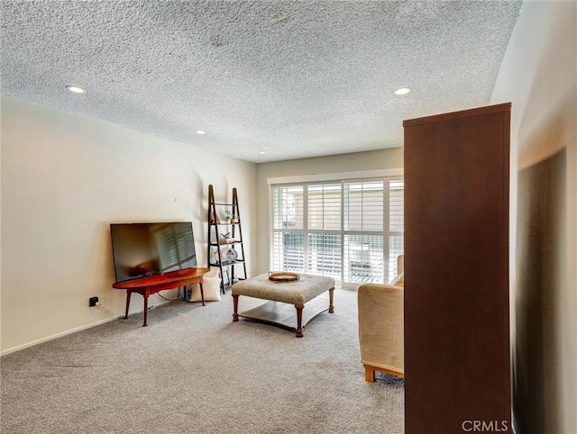 living room with carpet, baseboards, a textured ceiling, and recessed lighting