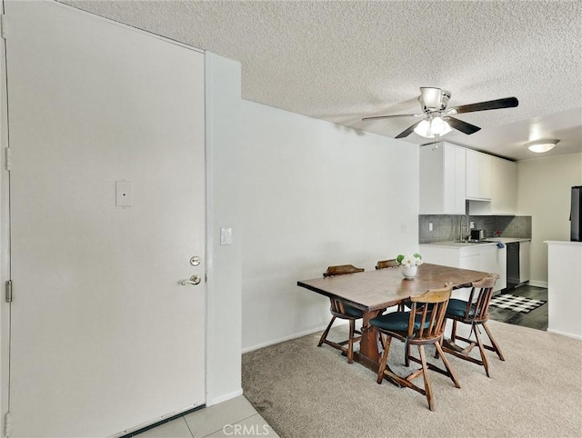 dining area featuring ceiling fan and a textured ceiling