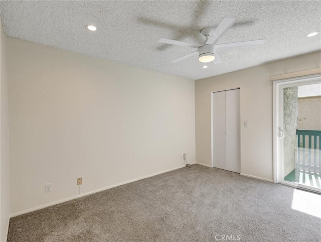 unfurnished bedroom with access to exterior, carpet, baseboards, and a textured ceiling