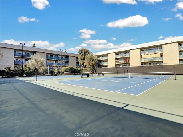 view of tennis court with fence