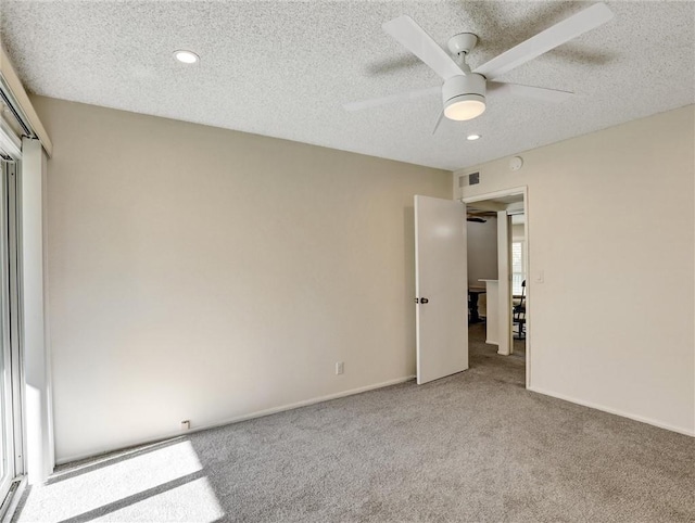 unfurnished bedroom featuring ceiling fan, a textured ceiling, and carpet flooring