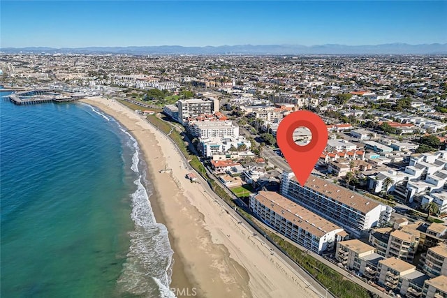 birds eye view of property featuring a water view and a view of the beach