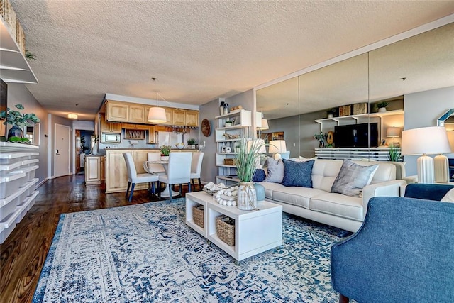 living room with dark hardwood / wood-style flooring and a textured ceiling