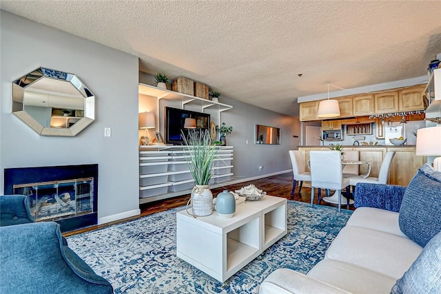 living room with dark wood-type flooring and a textured ceiling