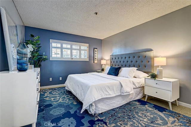 carpeted bedroom featuring a textured ceiling