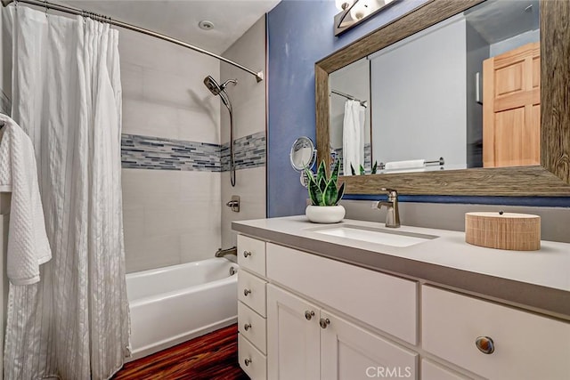 bathroom featuring hardwood / wood-style flooring, vanity, and shower / bath combination with curtain