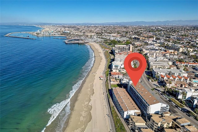 birds eye view of property featuring a water view and a beach view