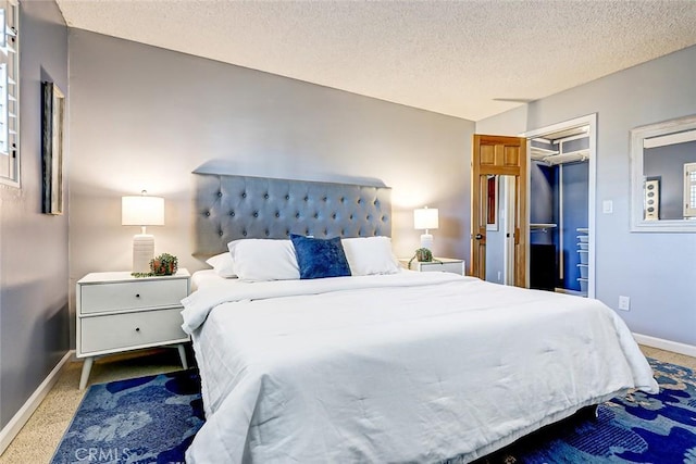 bedroom with carpet floors, a textured ceiling, and a closet