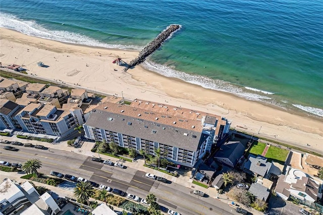 bird's eye view with a water view and a beach view