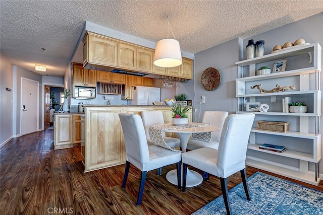 dining area featuring a textured ceiling and dark hardwood / wood-style flooring