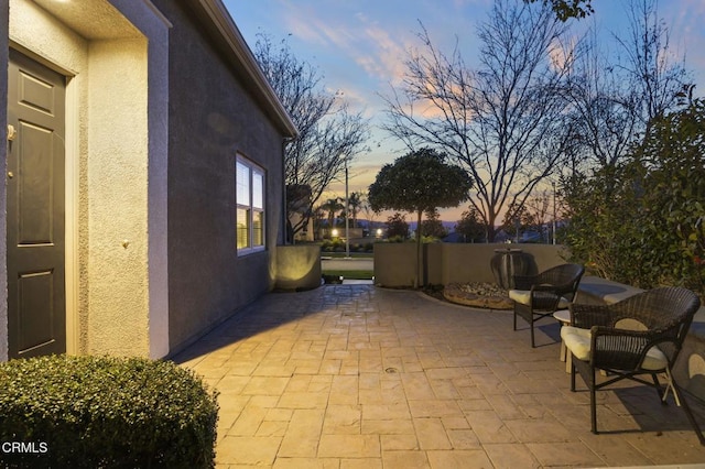 view of patio terrace at dusk